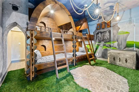Castle-themed bunk room with slide and mural