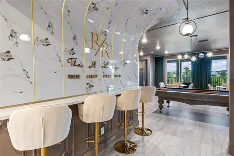 Marble RR bar with gold accents beside the billiards room