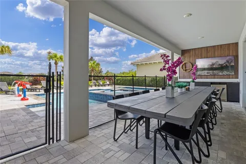Covered terrace dining beside the pool and golf course